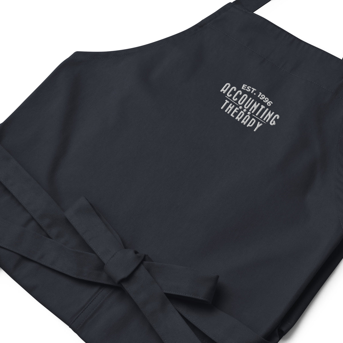 Product mockup - Close-up of organic cotton apron in dark blue showing rope neck strap detail and textured fabric stitching